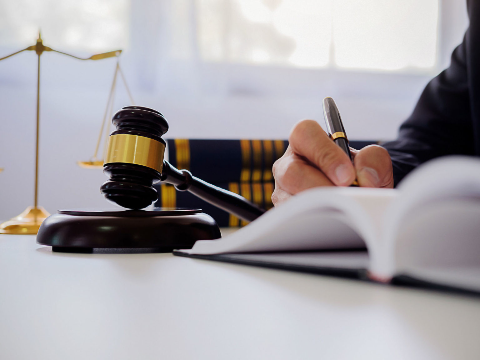 Judge gavel with Justice lawyers having team meeting at law firm in background. Concepts of law.