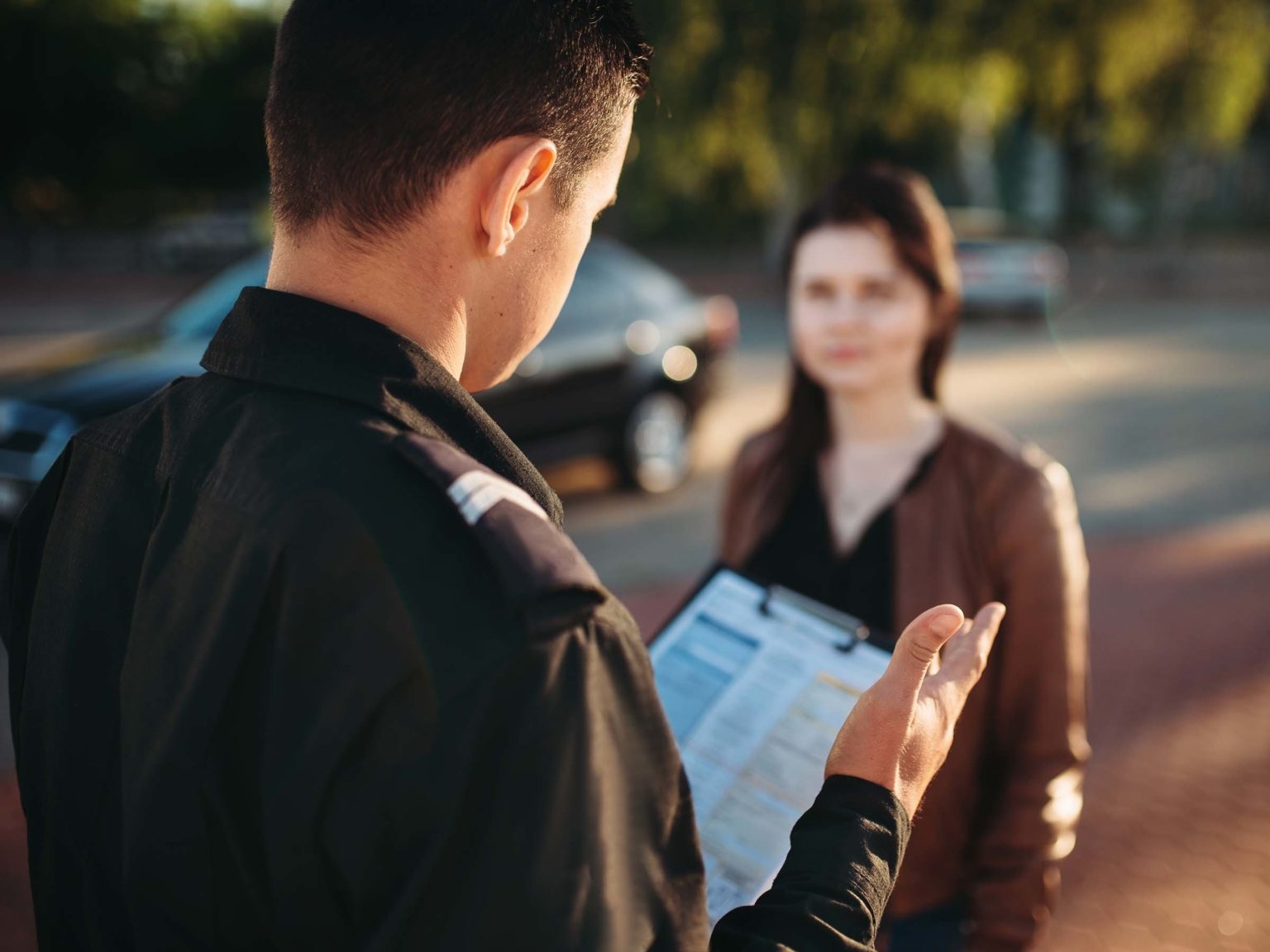 Police officers in uniform reads law to female driver. Law protection, car traffic inspector, safety control job